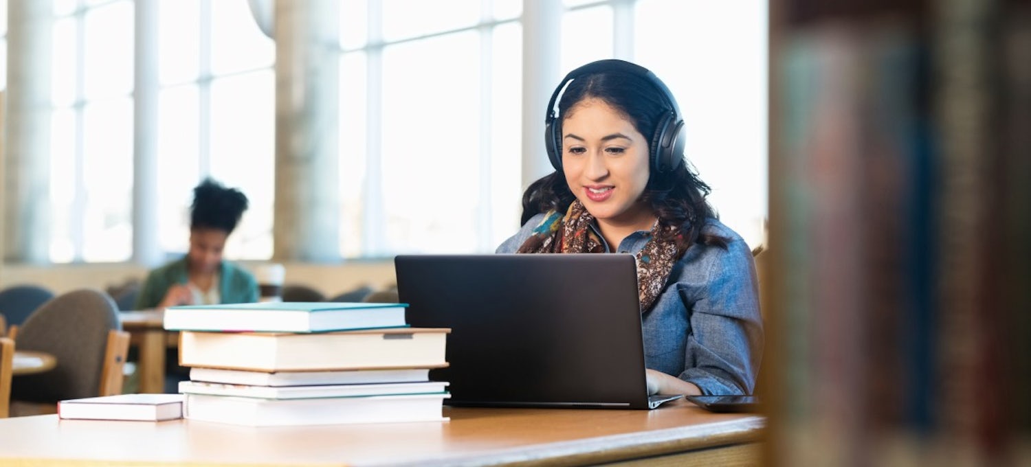 [Featured image] Woman at the computer taking an online class