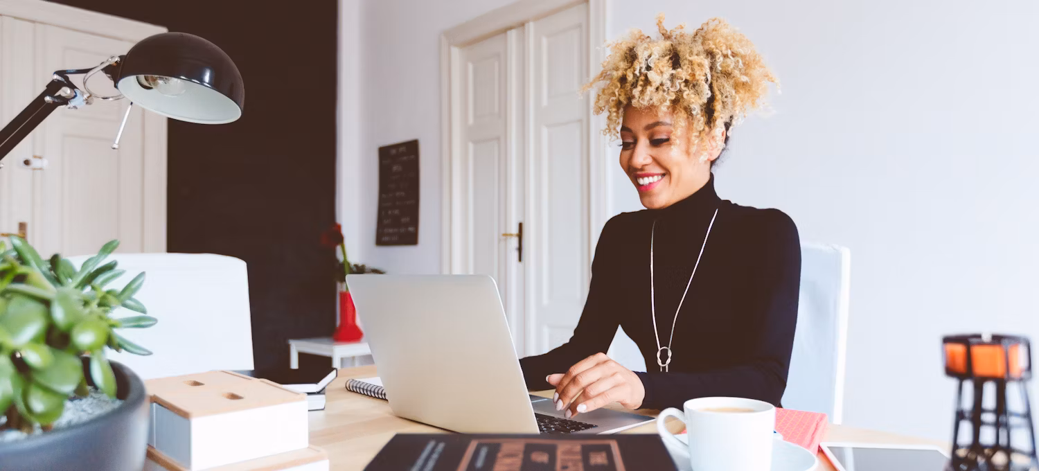 [Featured Image} A woman works on a laptop computer at a desk.