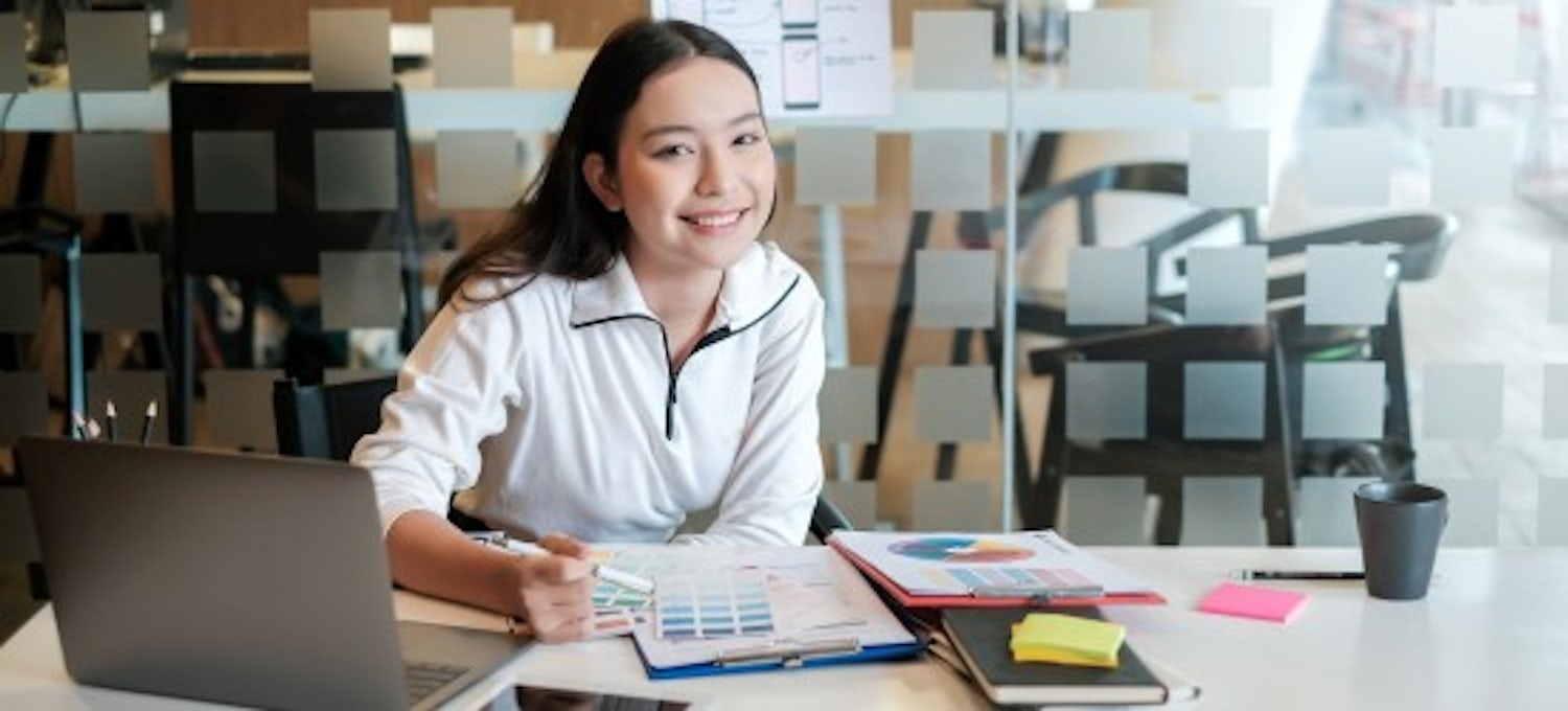 [Featured Image] A woman works at a desk.