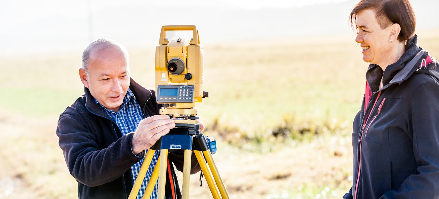 [Featured Image] A GIS analyst visits a surveyor in the field. 