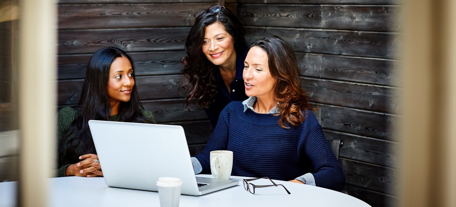[Featured image] A businesswoman is discussing a proposal on her laptop with her two other colleagues.