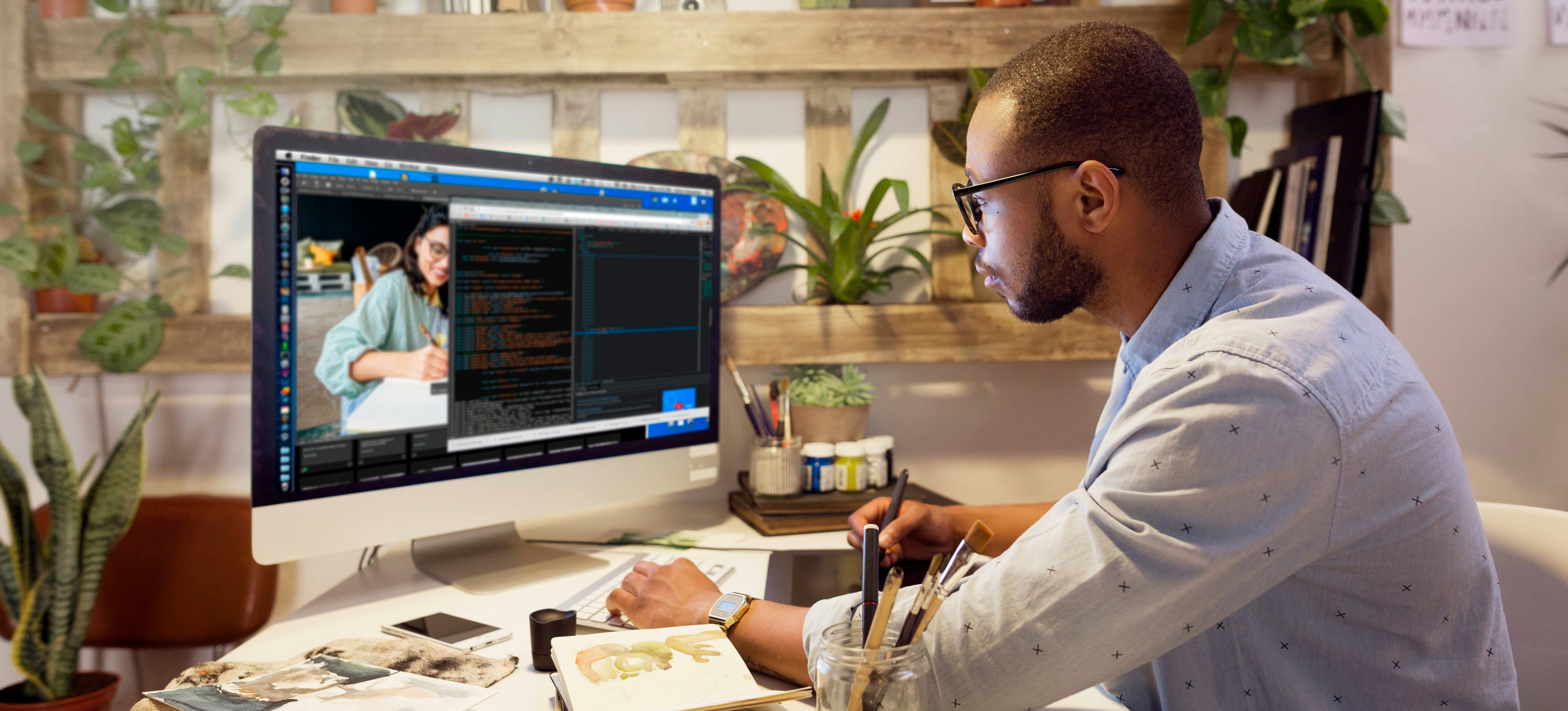[Featured Image] A web developer works on a desktop computer.