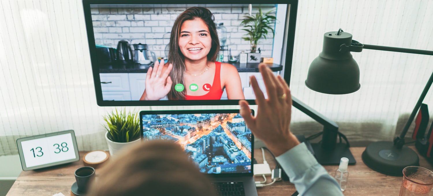 [Featured image] A person waves to a woman onscreen in a video call. 