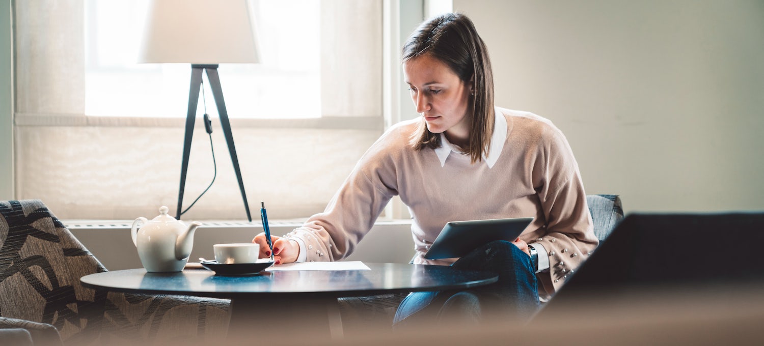 [Featured image] Woman at a desk working on a real estate appraisal