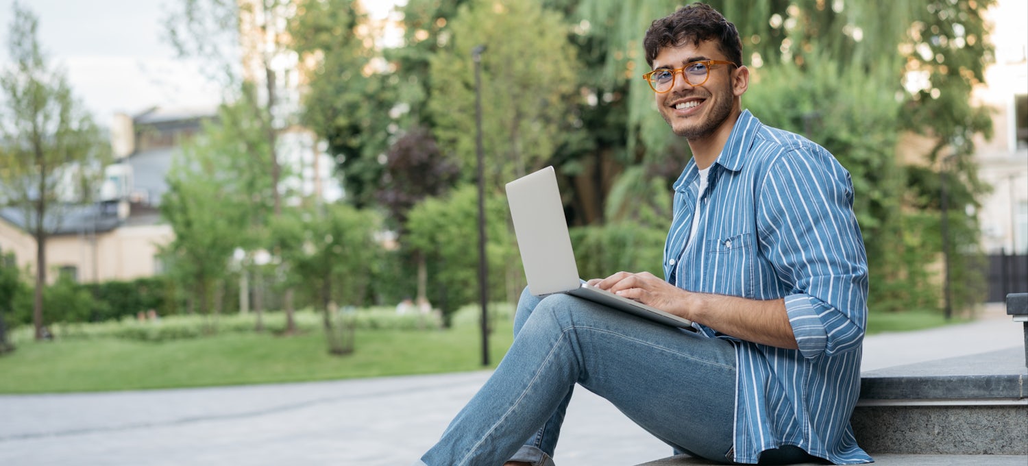 [Featured image] A college student sitting on a step outdoors applies to a data science internship on his laptop computer.