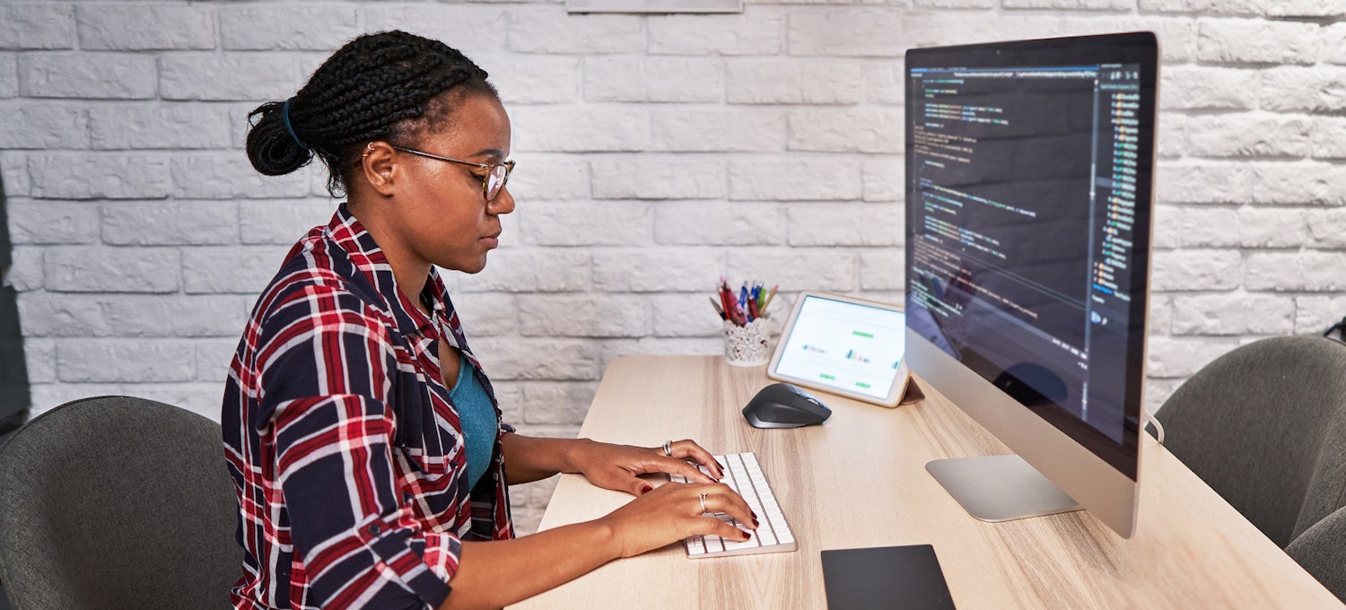 [Featured image] Woman at computer writing code