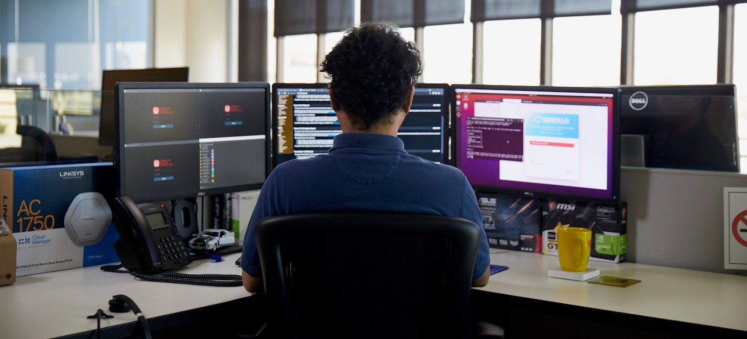 [Featured Image] An IT professional sits at a computer workstation and uses a scripting language to automate a task.