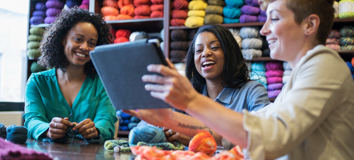 [Featured image] Three women work on a niche market plan for their yarn business.