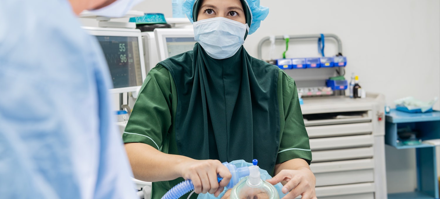 [Featured Image] A nurse anesthetist cares for a patient. 