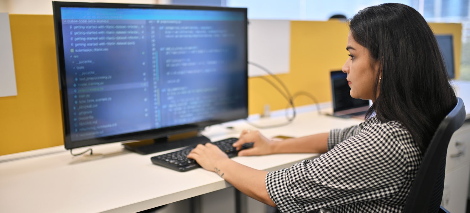 [Featured image] A programmer sits in front of a computer monitor and types code.