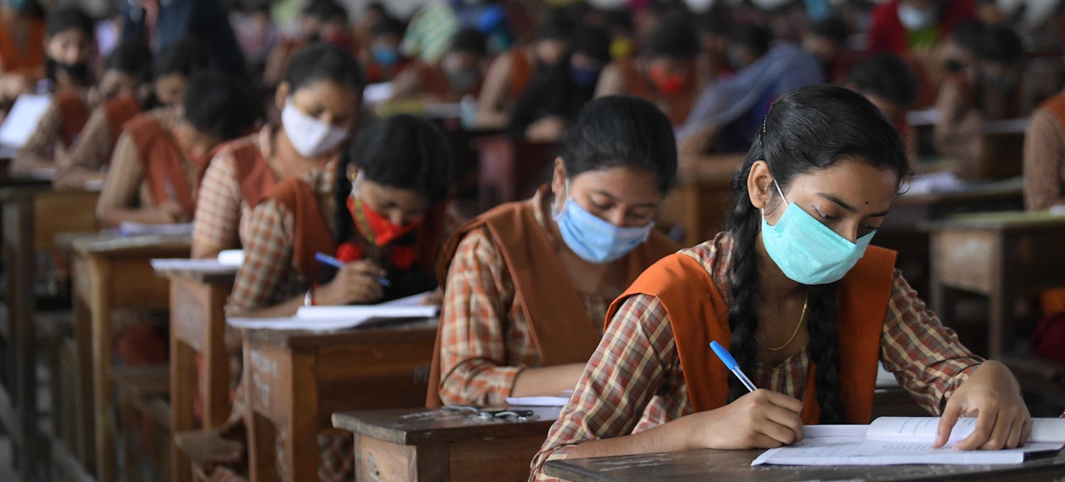 Students are seen writing their examinations.