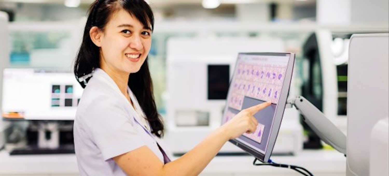 [Featured image] A medical technologist touches a monitor in a hospital setting.