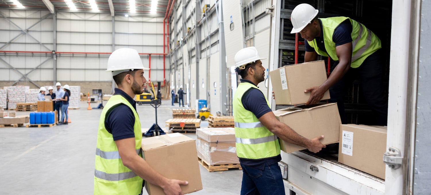 [Featured Image] A group of warehouse workers loading a delivery truck after the logistics of the delivery were determined through data, an example of a real-world data science application.
