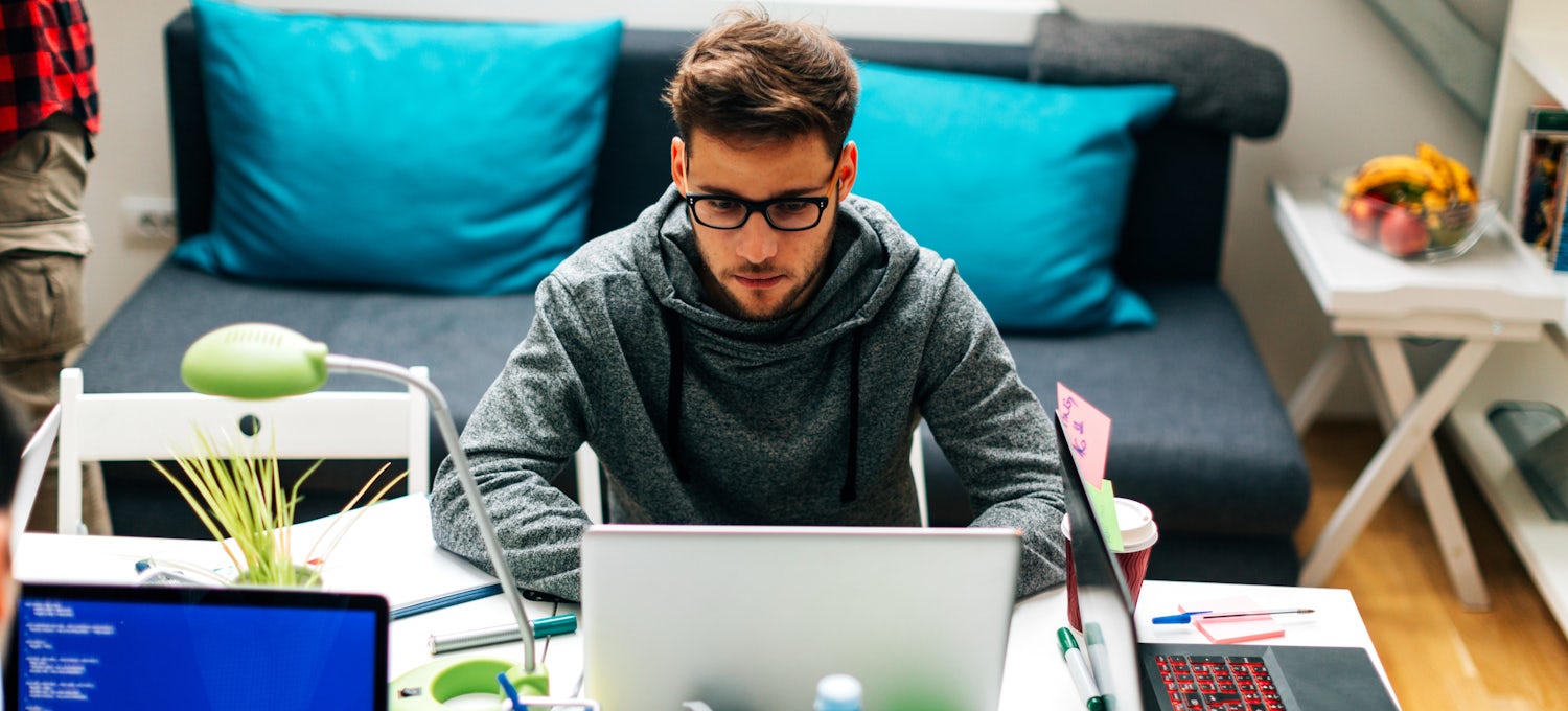 [Featured image] A machine learning intern wearing glasses and a grey hoodie sits in front of a laptop.