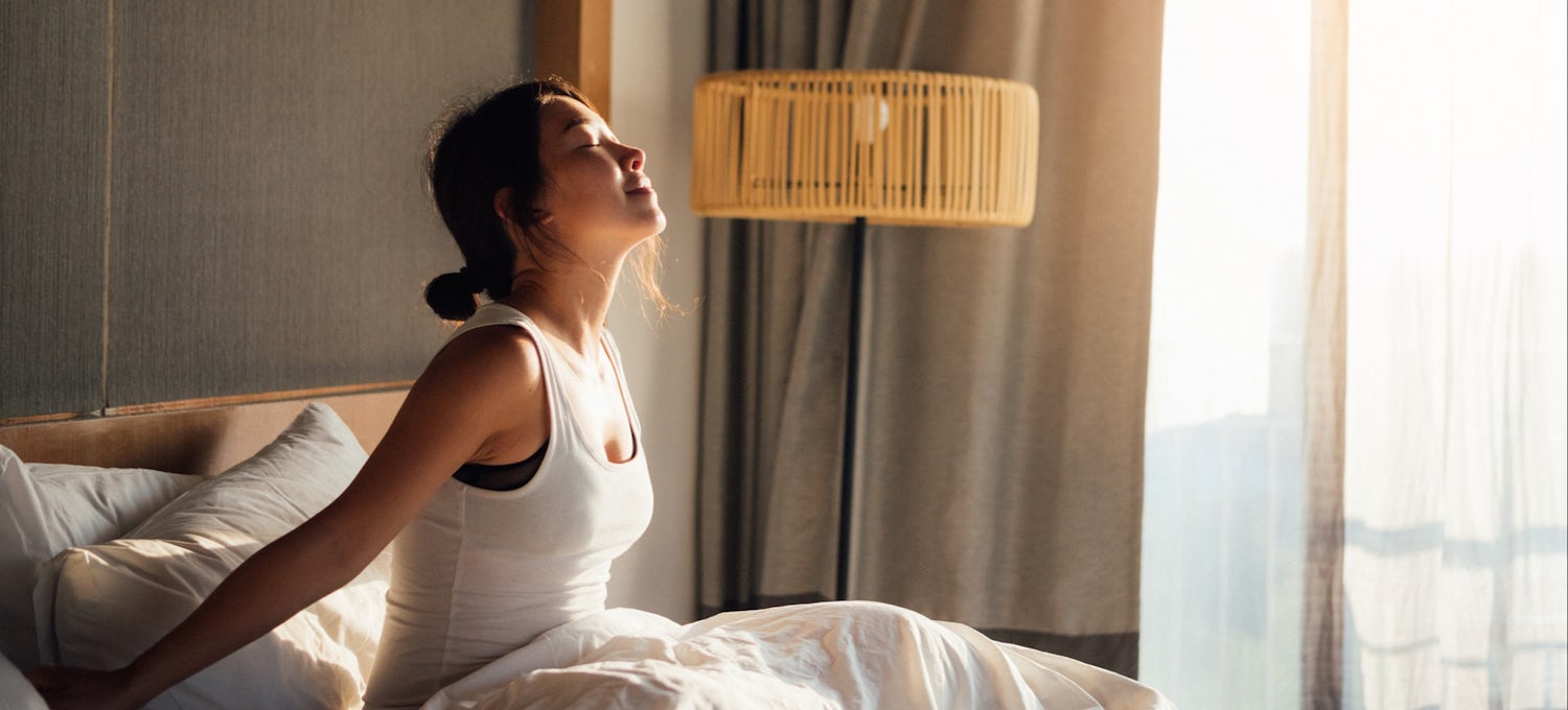 [Featured Image] A woman wakes up feeling refreshed.