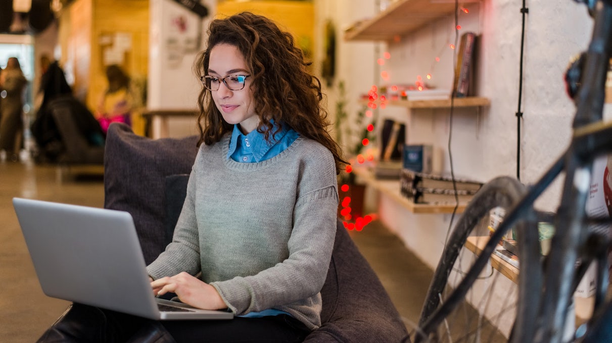 [Featured image] A software developer coding in Python on her laptop.