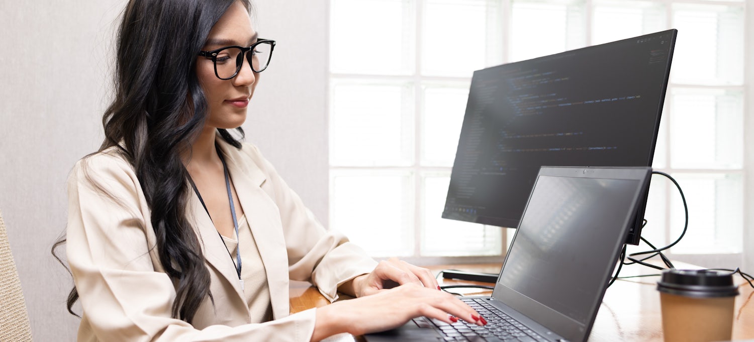 [Featured Image] A DevOps engineer practices her DevOps skills in her office.