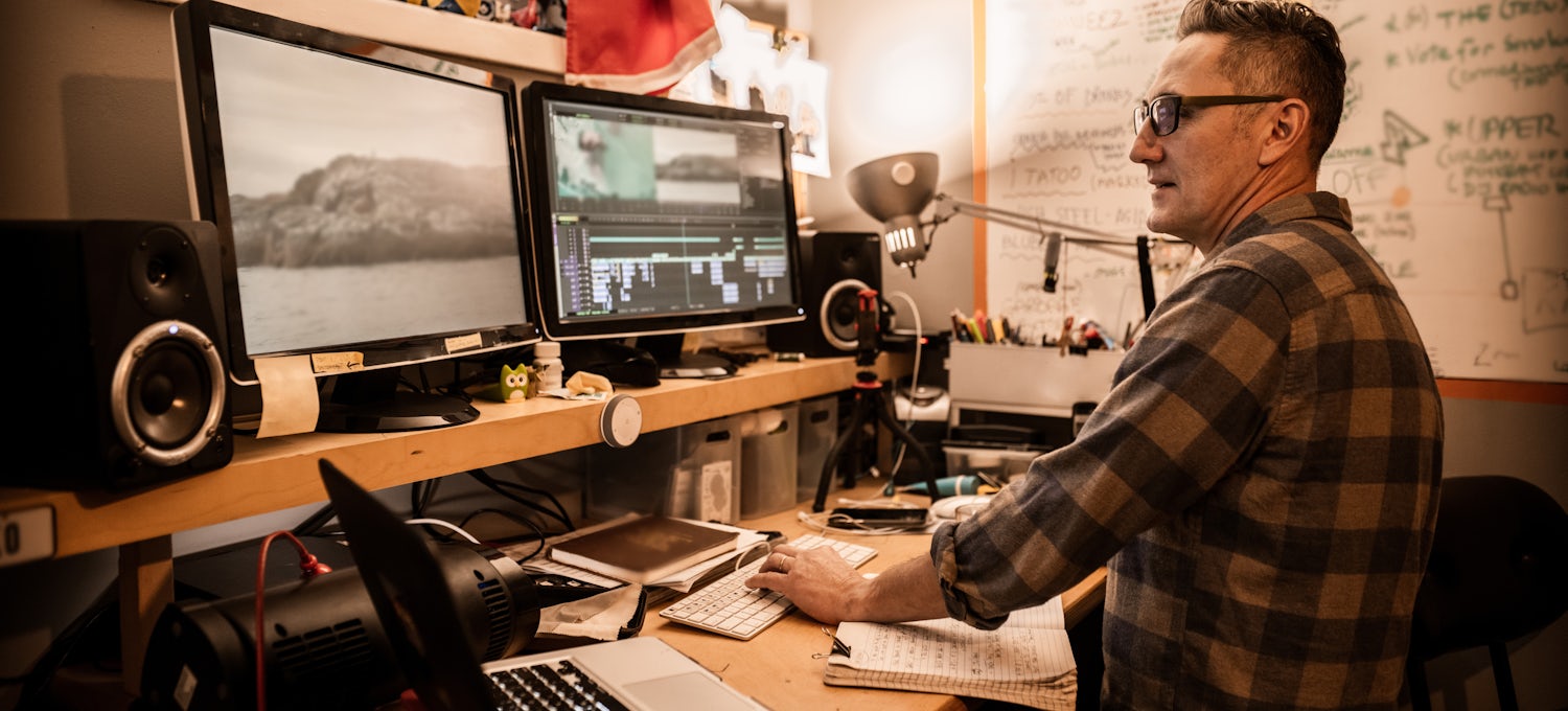 [Featured Image] A man shows off his video editing skills in his home studio.