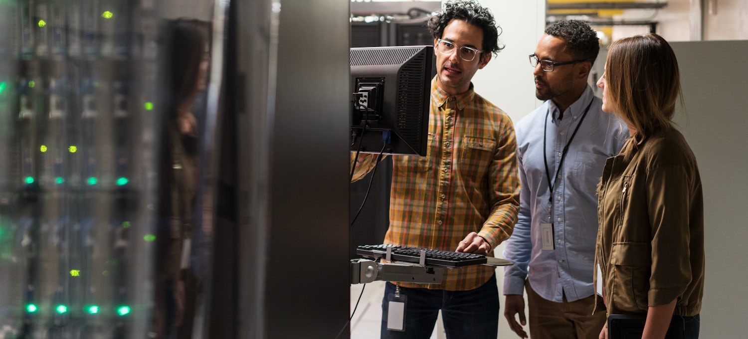 [Featured image] Three coworkers examine data servers.