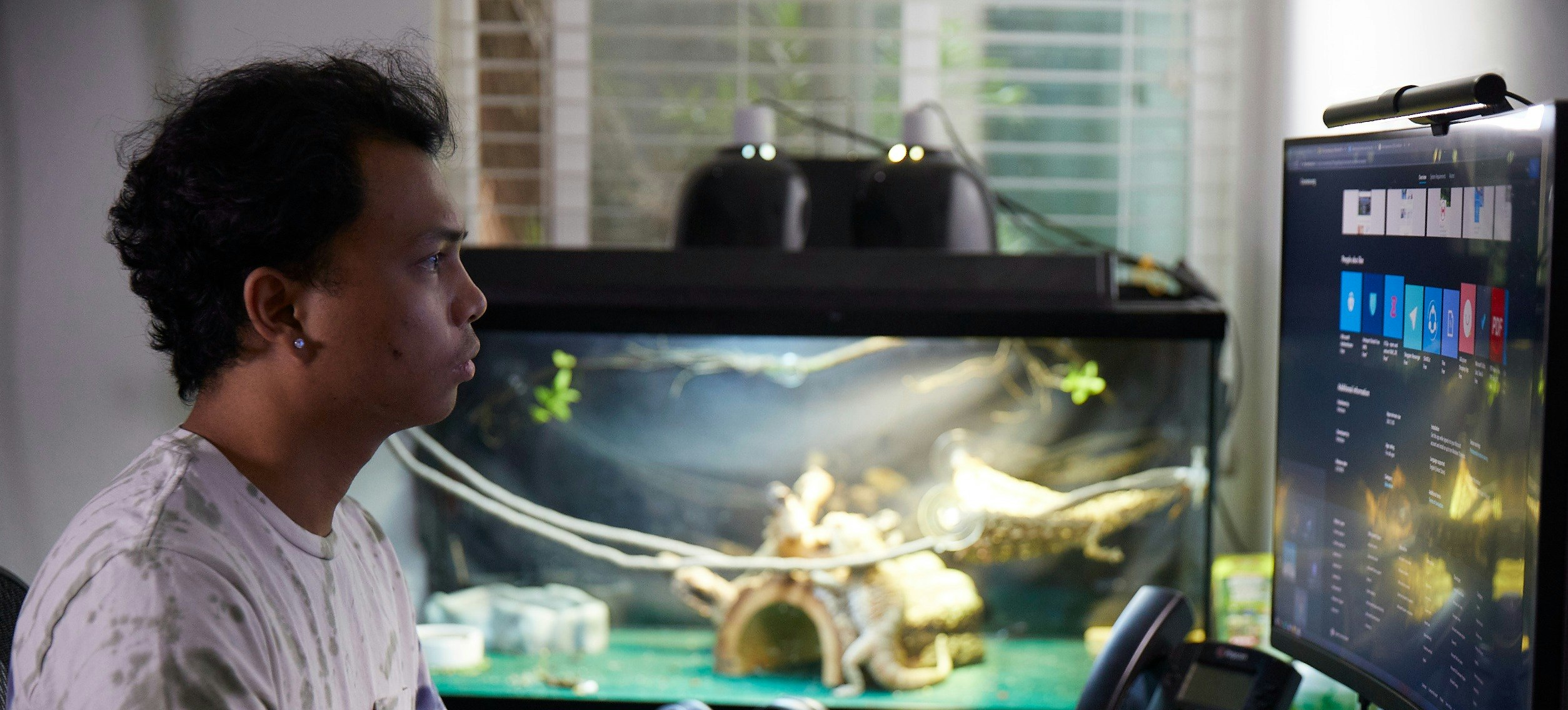 [Featured Image]  A computer programmer is working on a desktop computer, writing and testing a program for the project.